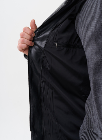 Пуховик из эко кожи с капюшоном из меха енота